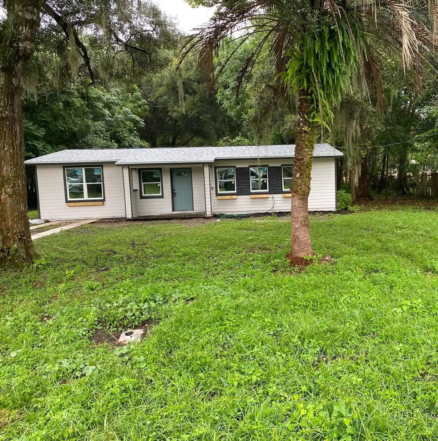 Single story home with new siding, shutters, roof and freshly painted front door